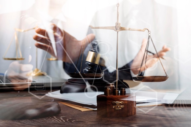 Justice and law conceptMale judge in a courtroom with the gavel working with computer and docking keyboard eyeglasses on table in morning light