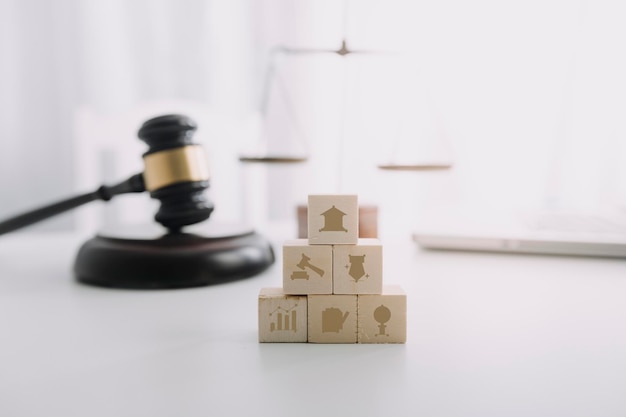 Justice and law conceptMale judge in a courtroom with the gavel working with computer and docking keyboard eyeglasses on table in morning light