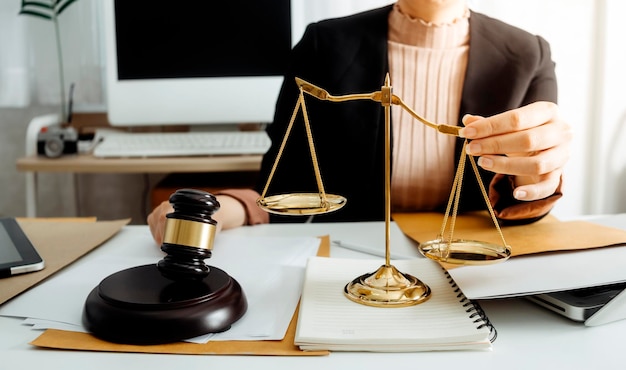 Justice and law conceptMale judge in a courtroom on wooden table and Counselor or Male lawyer working in office Legal law advice and justice concept