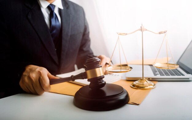 Justice and law conceptMale judge in a courtroom on wooden table and Counselor or Male lawyer working in office Legal law advice and justice concept