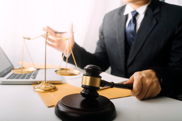 Justice and law conceptMale judge in a courtroom on wooden table and Counselor or Male lawyer working in office Legal law advice and justice concept