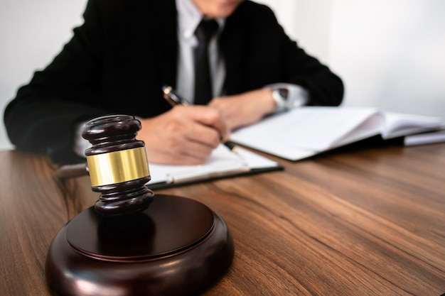 Photo justice lawyer or judge gavel working with legal documents in a court room