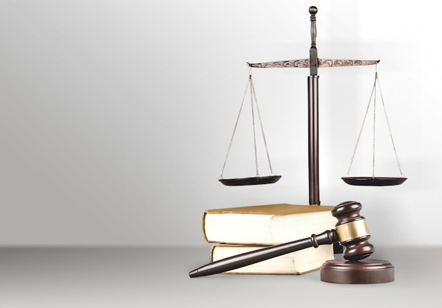 Justice Scales and book and wooden gavel on table. Justice concept