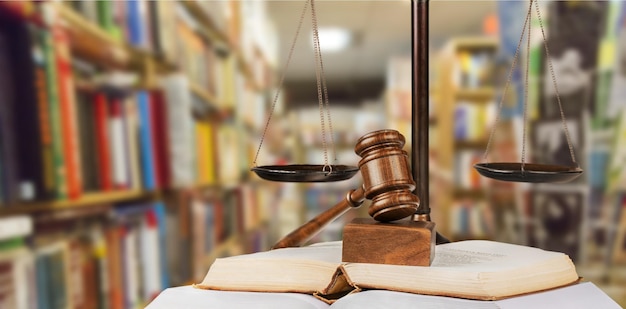 Justice Scales and books and gavel on wooden background