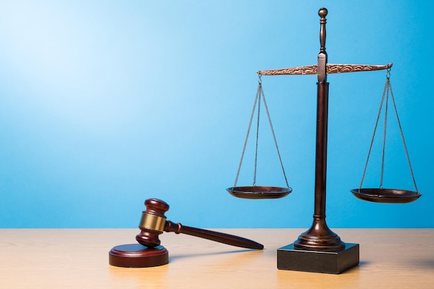 Justice Scales and wooden gavel on table