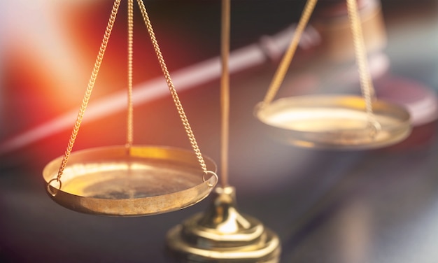 Justice Scales and wooden gavel on wooden table