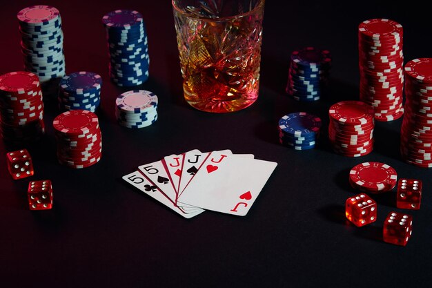 Kaarten van pokerspeler. Op tafel staan chips en een glaasje cocktail met whisky. Stilleven. Het concept van gokken. Online pokeren. Combinatie van kaarten