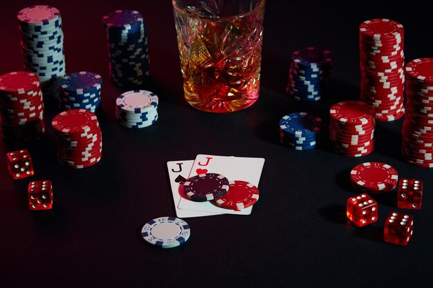 Kaarten van pokerspeler. Op tafel staan chips en een glaasje cocktail met whisky. Stilleven. Het concept van gokken. Online pokeren. Combinatie van kaarten