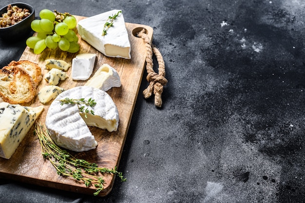 Kaasplank met Franse camembert, brie en blauwe kaas, druiven en walnoten.