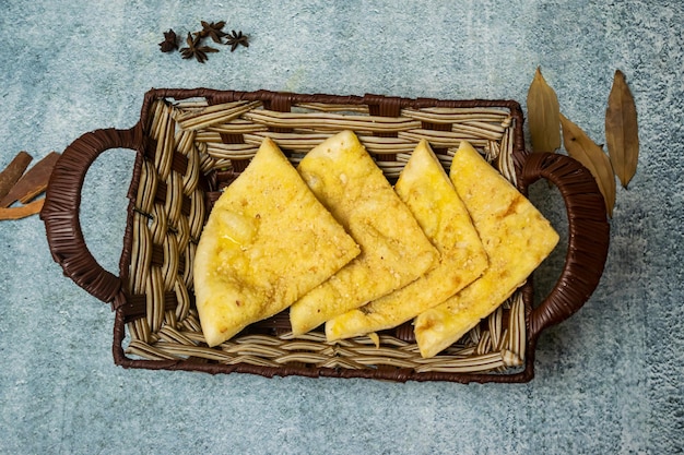 Kabli Naan or afghani nan served in a basket isolated on grey background top view of bangladesh food