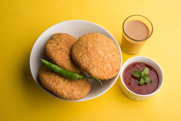 Kachori is a Flat spicy snack from India also spelled as kachauri and kachodi. Served with tomato ketchup. Selective focus