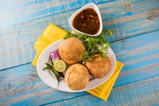 Kachori is a spicy snack from India also spelled as kachauri and kachodi. Served with tomato ketchup. Selective focus