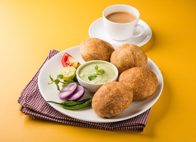 Kachori is a spicy snack from India also spelled as kachauri and kachodi. Served with tomato ketchup. Selective focus