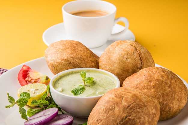 Kachori is a spicy snack from india also spelled as kachauri
and kachodi. served with tomato ketchup. selective focus