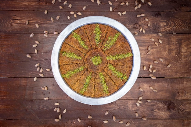 Kadayif dessert in tray on wooden background