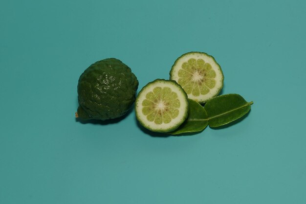 Kaffir limes isolated on green background