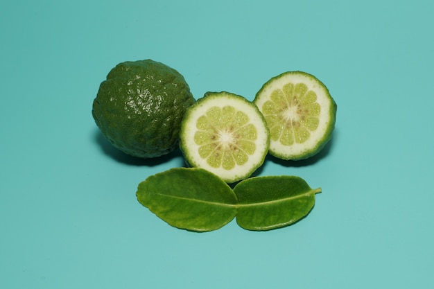 Kaffir limes isolated on green background