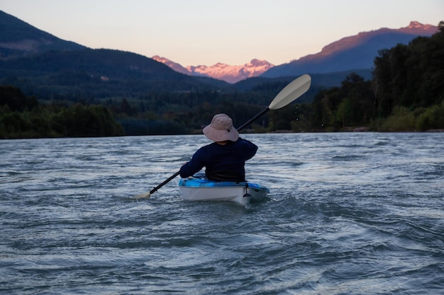 Kajakken in een rivier omringd door Canadian Mountains