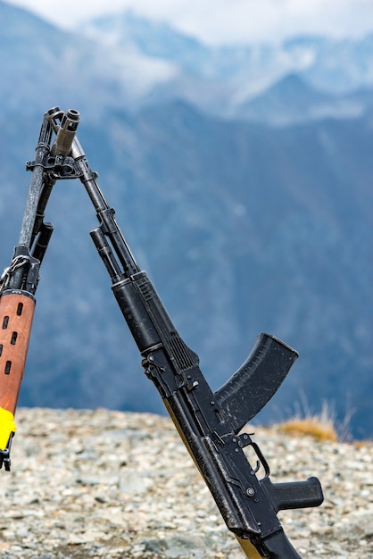 Kalashnikov assault rifles on the background of the Caucasus mountains.