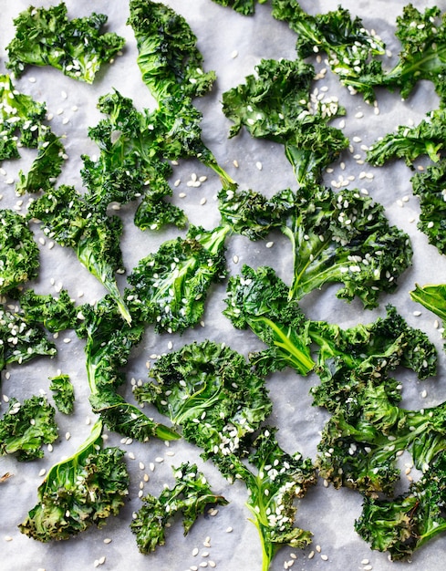 Kale chips healthy snack on parchment paper Top view