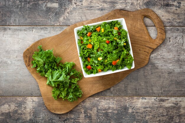 Kale salad and ingredients on cutting board Top view