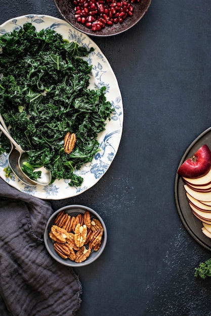 Kale salad with pomegranate and apple with pecans food photography