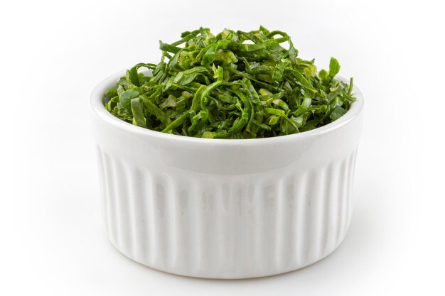 Kale sliced in ramekin isolated on white background