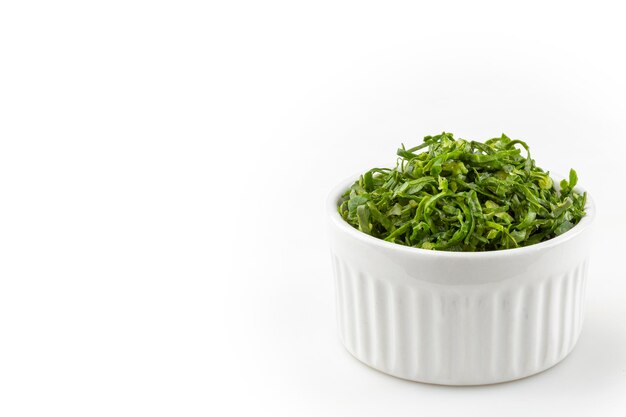 Kale sliced in ramekin isolated on white background