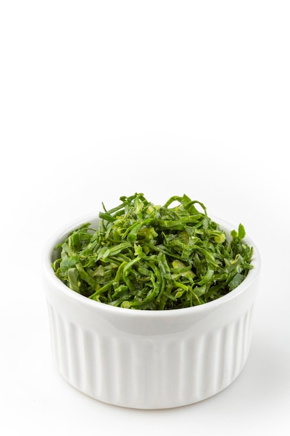 Kale sliced in ramekin isolated on white background