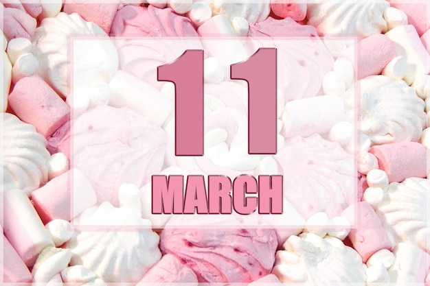 Kalenderdatum op de achtergrond van witte en roze marshmallows 11 maart is de elfde dag van de maand