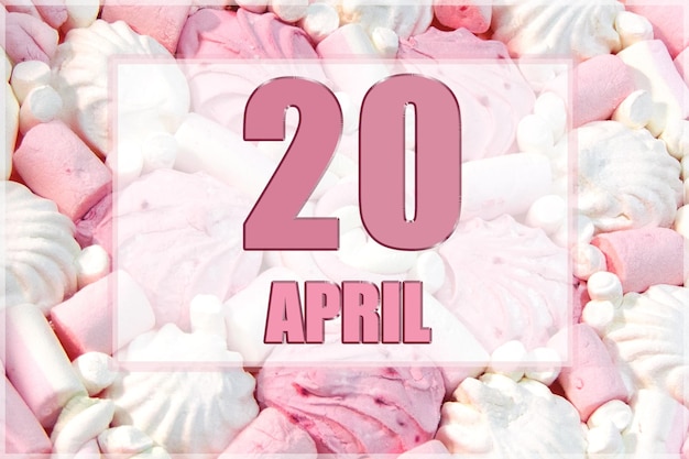 Kalenderdatum op de achtergrond van witte en roze marshmallows 20 april is de twintigste dag van de maand