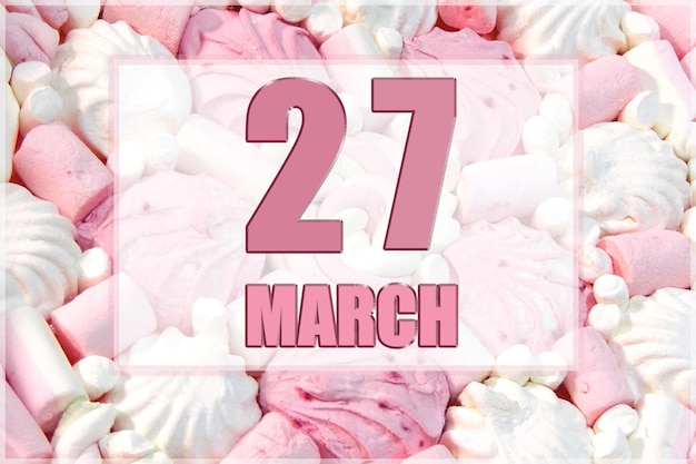 Kalenderdatum op de achtergrond van witte en roze marshmallows 27 maart is de zevenentwintigste dag van de maand