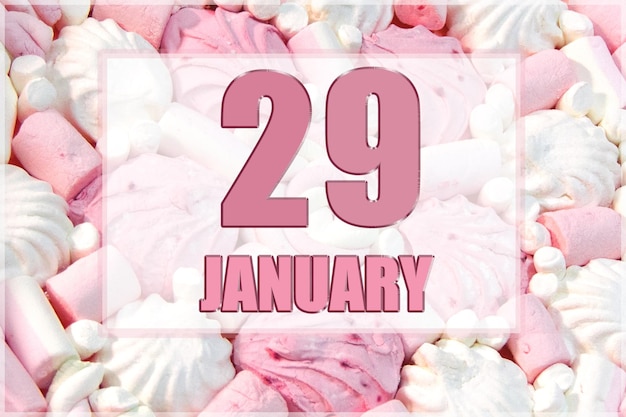 Kalenderdatum op de achtergrond van witte en roze marshmallows 29 januari is de negenentwintigste dag van de maand