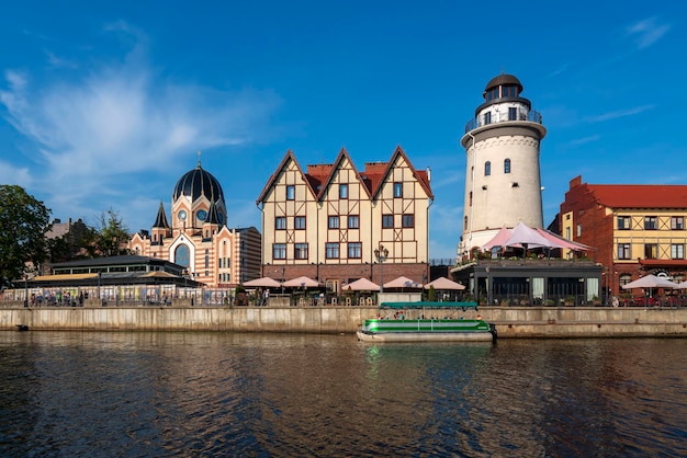 Kaliningrad Rusland 06282022 Uitzicht op de dijk van de Pregolya-rivier het vissersdorp de Konigsberg-vuurtoren de nieuwe Kaliningrad-synagoge op een zonnige zomerdag