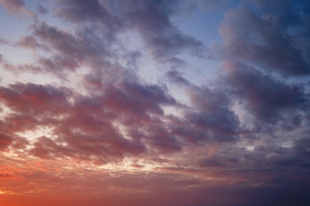 Kalme zee met avondrood en zon door de wolken over