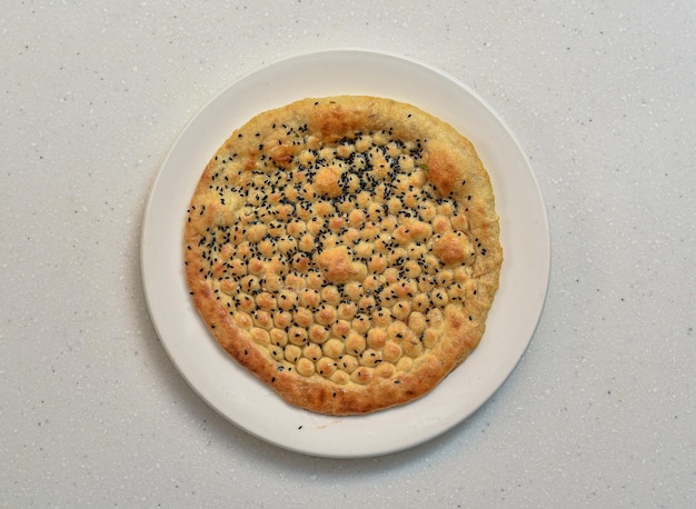 Kalonji naan or kalwangi naan served in a dish isolated on grey background top view of indian pakistani food