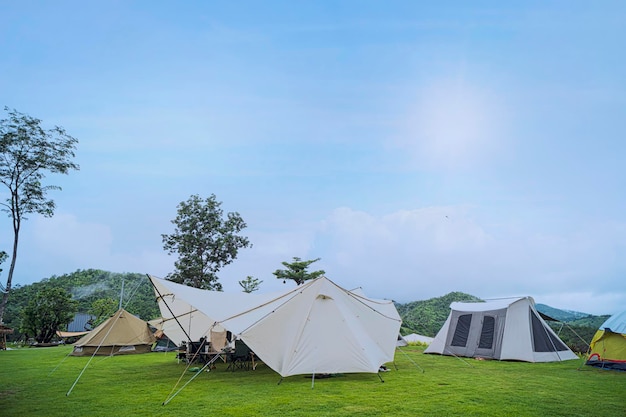 Kampeer en zet een tent op onder het bos op de heuvel met een prachtige ochtendzon