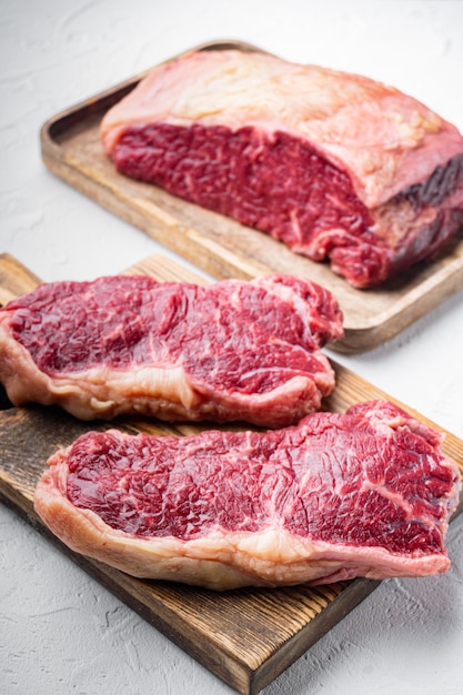 Kansas city raw organic beef steak cut, on white table