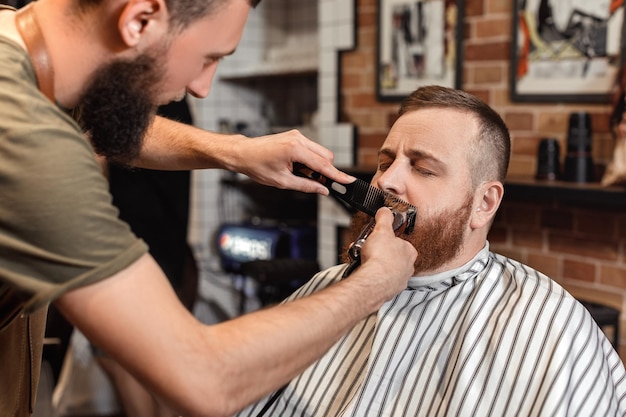 Kapper en bebaarde man in kapperszaak