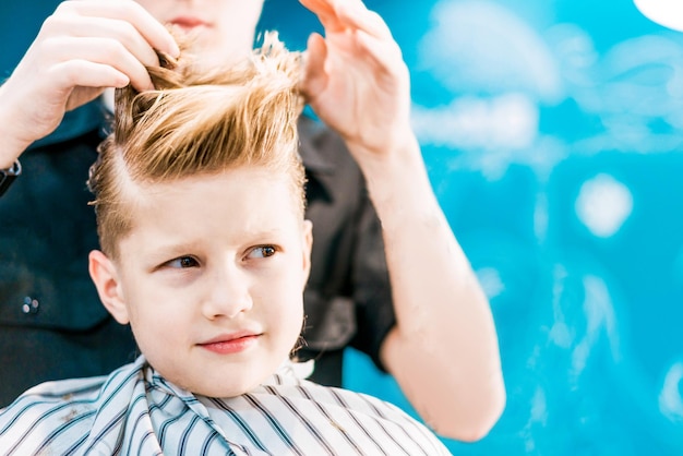 Kapsel van een kleine jongen in de kapperszaak