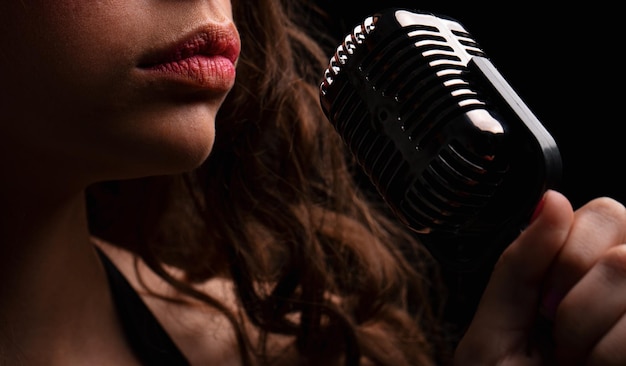 Karaoke closeup woman with vintage microphone lips sensual girl singer concert sing