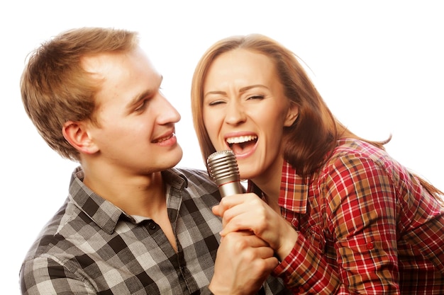 Karaoke Lovely couple with microphone Young and beauty Hipster style Over white background