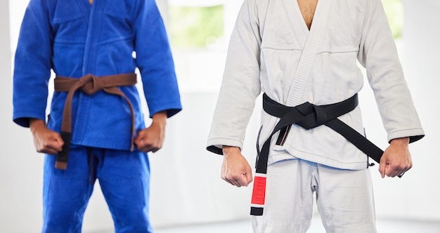 Karate dojo and men in uniform for training exercise or a fight competition tournament or championship MMA martial arts and fighter athletes in a gi suit for a workout or practice in a gym