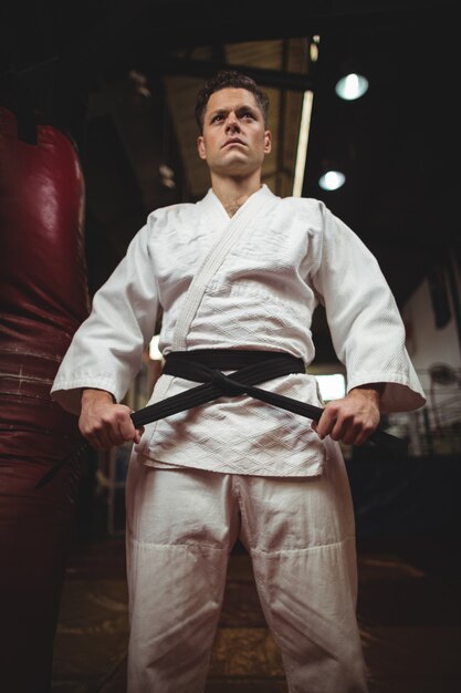 Photo karate player tying his belt