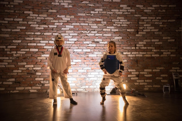 Karate training in the studio two little girls standing in karate training clothes