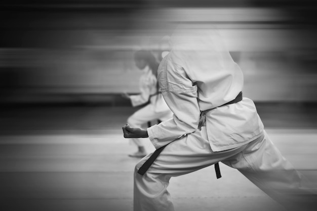 Photo karatedo training and a healthy lifestyle added blur effect for more motion effect retro style with imitation film grain black and white