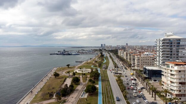 Karsiyaka - Izmir - Turkey, March 20, 2022, Around the Yunuslar statue with an aerial view of the city and the sea with drone