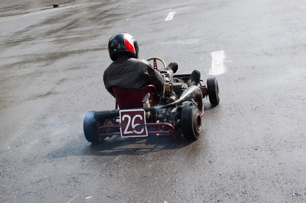 Karting - driver in helmet on kart circuit