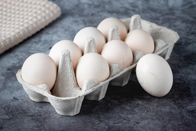 Kartonnen doos met eieren op grijze tafel