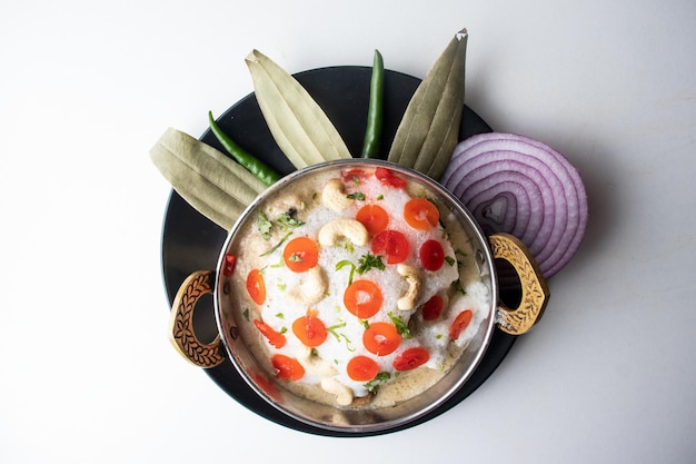 Kashmiri Chicken karahi with onion and chili served in a dish isolated on grey background top view of bangladesh food